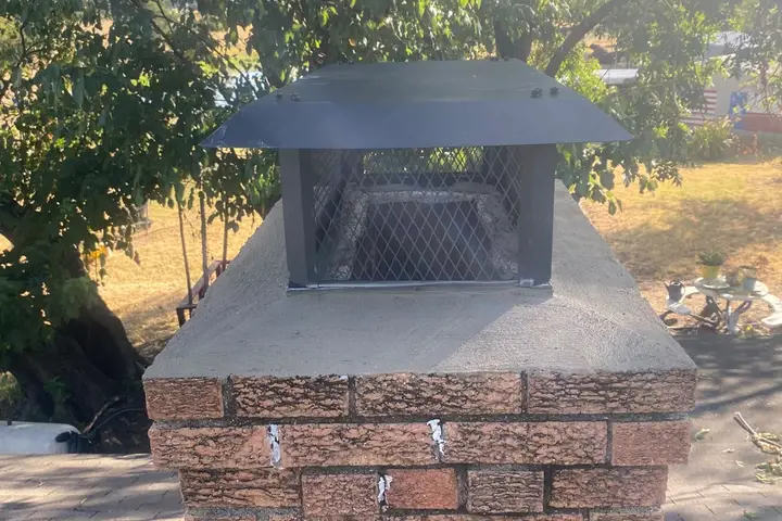 New chimney cap installed on a brick chimney by Dallas Chimney Care